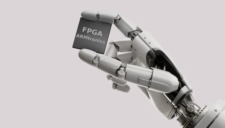 Robotic hand holding an Armtronics FPGA chip