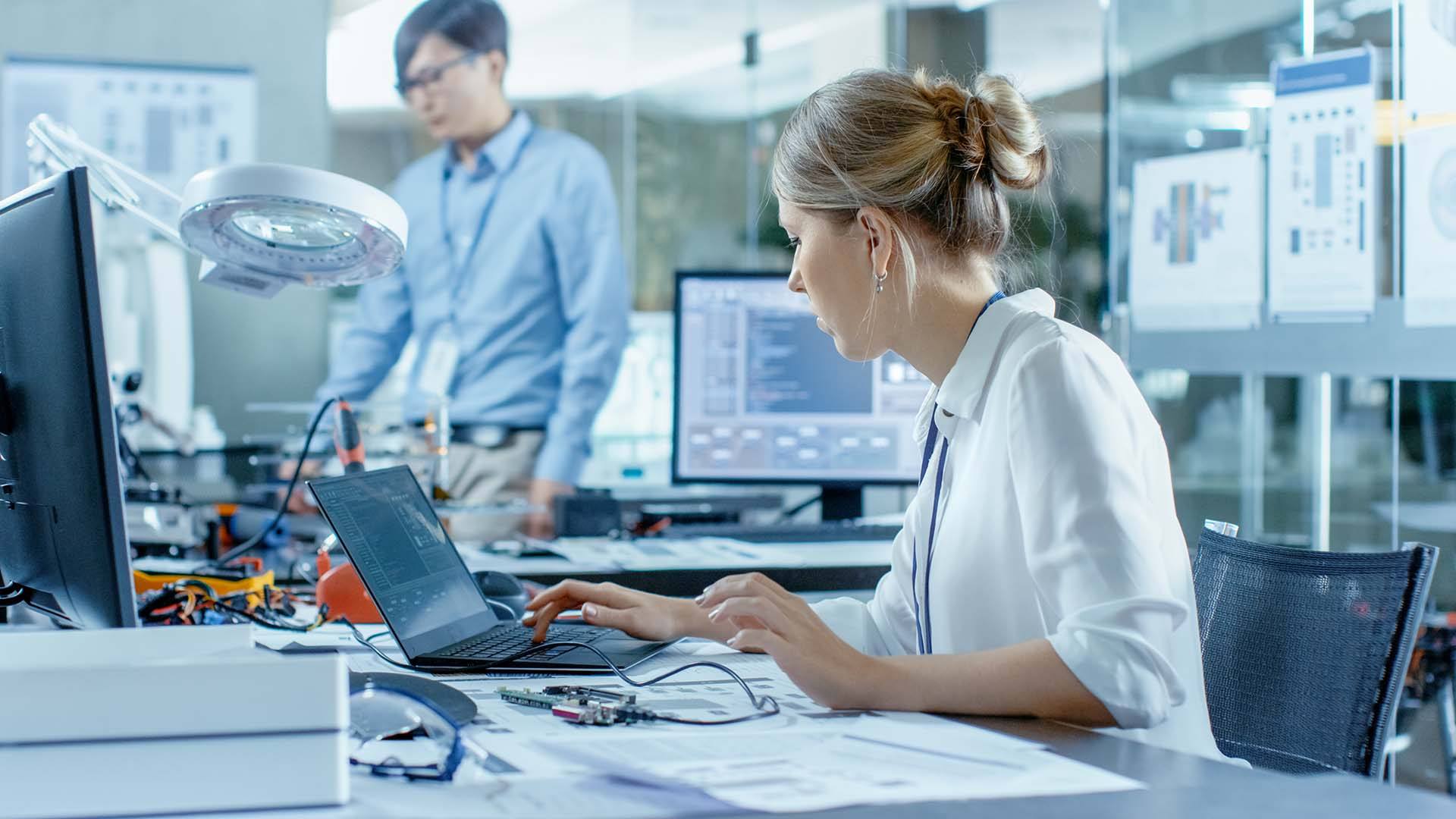 Engineers working together on hardware and software in a lab